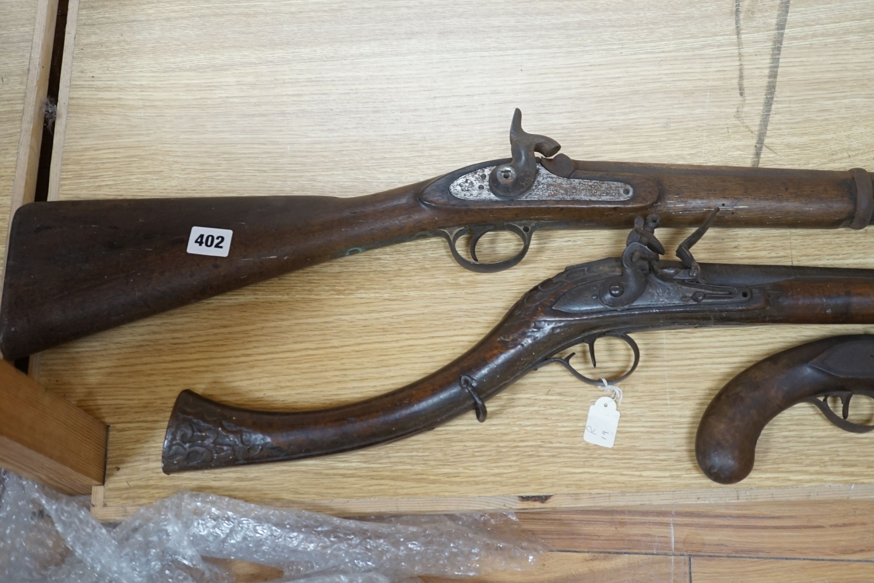 A Continental flintlock musket, a Victorian percussion musket stamped VR beneath a crown and Pimlico 1854 an incomplete 19th-century flintlock pistol